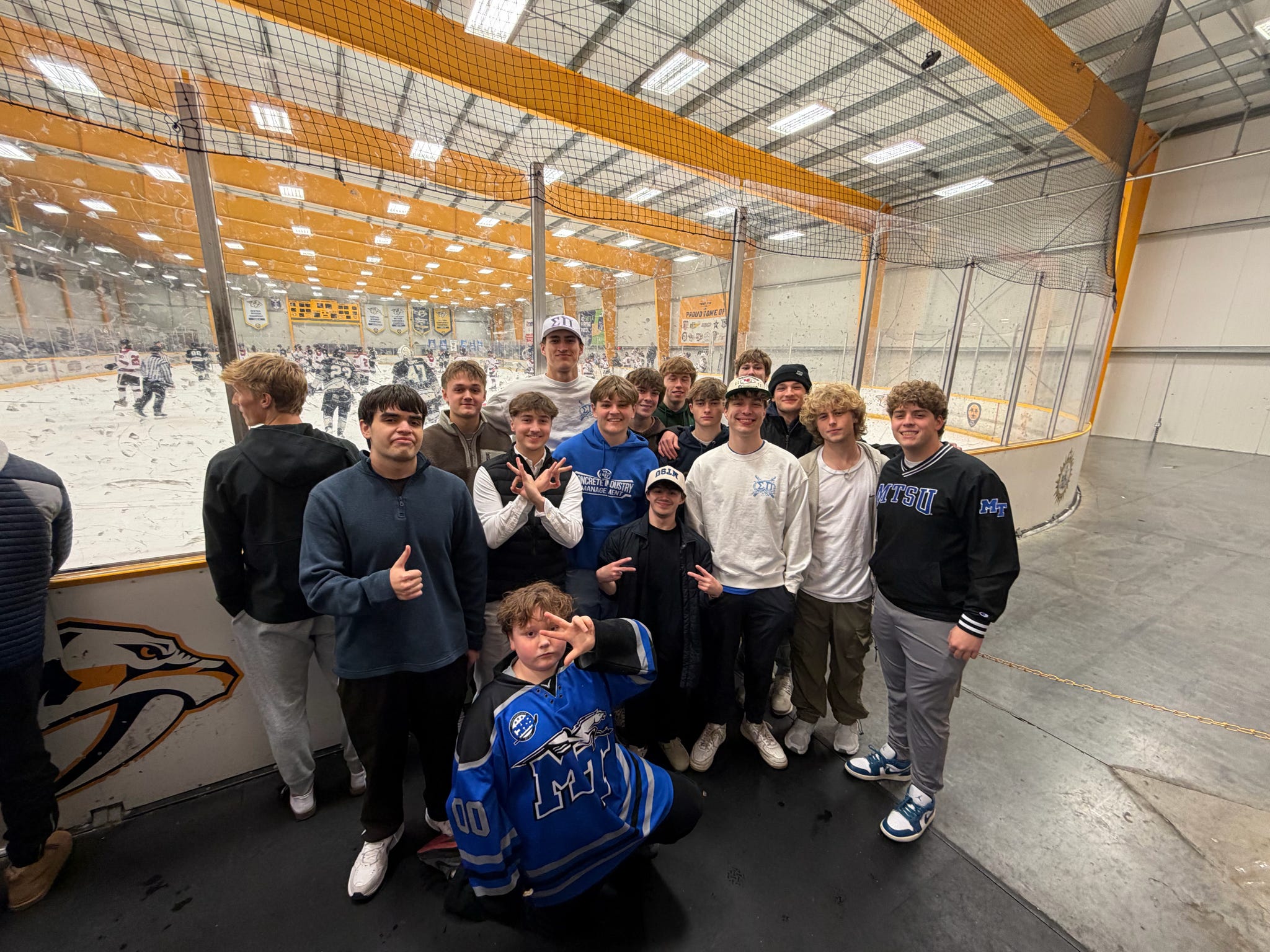 Theta-Omega brothers attending an MTSU hockey game